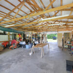 Open ceiling exposing wood ceiling framing