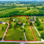 Aerial view of beautiful log cabin on 5 acres.
