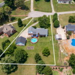 aerial view of back of home with a pool