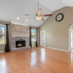 living room with fireplace and view of kitchen