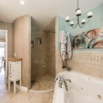 Master Bath with stand alone shower and bath tub at lakefront property