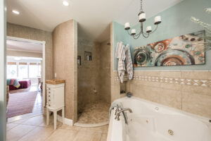 Master Bath with stand alone shower and bath tub at lakefront property