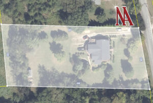 Aerial view of the 3,647± sq. ft. home, showcasing its expansive lot, mature trees, and peaceful residential setting.